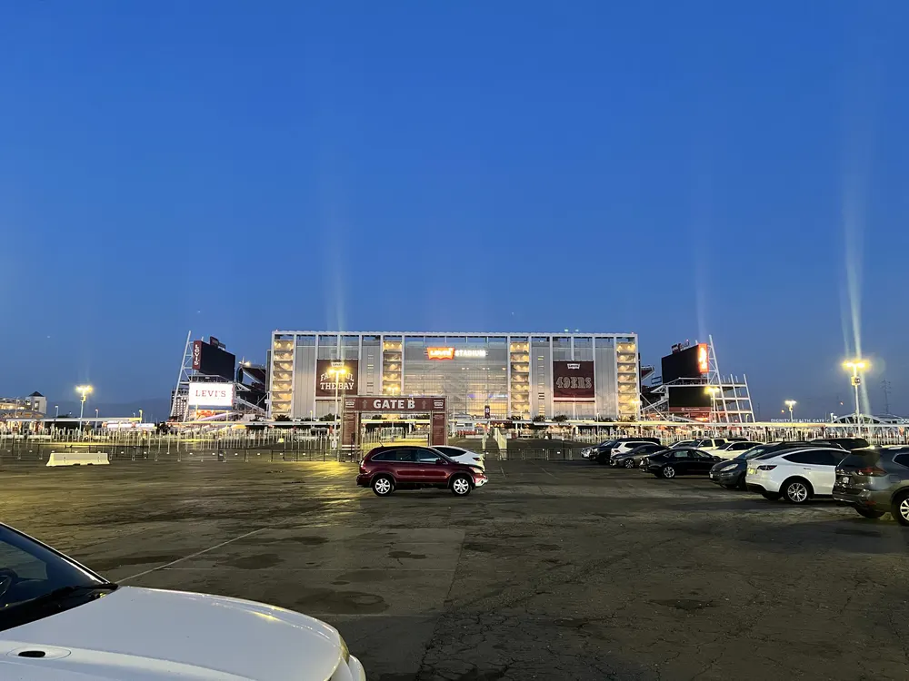 Levi's Stadium at dusk, seen across a parking lot